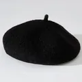 Detail view of a black fuzzy beret hat featuring soft plush texture for winter - One Size / Obsidian Black