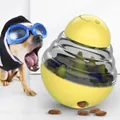 Yellow tumbler dog toy slow feeder puzzle ball with treats for pet entertainment. - Tumbler Toys / Yellow