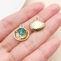 Close-up view of golden ocean shell pendants featuring a sparkling blue crystal inlay - Gold Blue Rhinestone Shell (28172)