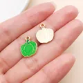 Detail view of green enamel pumpkin charms with golden textured back for jewelry making. - Bell Pepper (27961) / 1 Piece/Pack (15.5x12mm) / Green