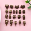Macro view showing various antique bronze bail beads with retro patterns for DIY jewelry. - Mixed Styles (SN853)