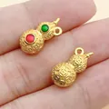 Detailed view of matte gold gourd pendants featuring intricate patterns and colorful enamel. - Red Heavy Gourd Pendant (22574) / 1 Piece (16x8mm)