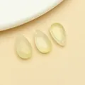 Close-up of shimmering teardrop glass beads for DIY hairpins and accessories - Medium Glass Teardrop Bead With Hole (23686) / 10 Pieces Pack (14x8x5mm) / Yellow Iridescent Gold Glitter