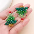Close-up of handmade beaded Christmas tree pendants with colorful crystal beads. - Green Crystal Beaded Christmas Tree (28618) / 1 Piece (39x32x8mm)