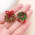 Detail shot of handmade beaded Christmas wreath charms for jewelry DIY and crafts accessories. - Green Crystal Beaded Bow Wreath (28622)