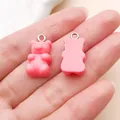 Detailed view of two pink resin gummy bear charms showing front and back on a palm. - Bear Candy (12575) / 1 Piece (10x20mm) / Rose Red