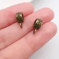 Macro detail of antique bronze scroll pattern pendant bails for DIY jewelry making - Spiral Pattern Bail (20672)