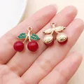 Close-up of red cherry pendants with green rhinestones and gold hammered leaves - KC Gold Red Resin Green Rhinestone Cherry (Style 3)