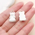 Close-up detail view of two cute white resin gummy bear charms for DIY jewelry making - Bear Candy (12576) / 1 Piece/Pack (10x20mm)