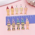 Detailed view of colorful koi fish enamel charms with ruler for size reference - Colorful