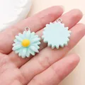Close-up detail showing the front and back of a light blue resin daisy charm held in hand - Little Daisy Flower (24599)
