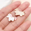 Handmade pink and white enamel unicorn charm for DIY jewelry making shown on a palm - Pink Pony (27637)
