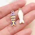 Colorful enamel koi fish charms for DIY jewelry making shown on hand for scale - Ocean Fish (27538) / 1 Piece (25x8mm) / Purple