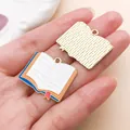 Open book enamel charm pendant featuring colorful details and a golden textured back - Orange Book (27462)
