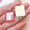 Detailed macro view of the front and back of coffee menu enamel charms for DIY crafts - Coffee Menu (27174) / 1 Piece (28x18mm) / Pink