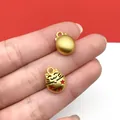 Detailed view of a gold lucky cat pendant with red stars for DIY jewelry - 1 Piece (14x10mm)