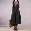 Detailed view of long sleeveless black denim dress with hood and button closure - XL / Dresses / Black