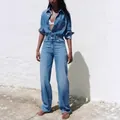 Full view of a stylish women's denim long-sleeved jumpsuit with lapel and pockets - S / Jumpsuits / Dark Blue