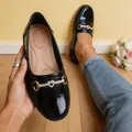 Close-up of black patent leather loafers for women with heart rhinestone buckle detail - 36 / Black