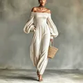 Elegante tuta con spalle scoperte e maniche a sbuffo in tessuto stropicciato crema - Taglia S / Bianco