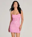 A detail shot of a stunning shimmering pink sequin mini dress worn by a model in a studio. - L / Dresses / Pink