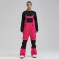 Professional women's winter ski bib in hot pink and black for snowboarding outdoors - Magenta and Black