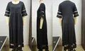 Detail view of plus size black dress featuring mesh patchwork on sleeves and the bottom hem - 3XL / Black Style