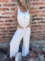 Close-up detail of a summer white loose-fit sleeveless jumpsuit with buttons and pockets - 4XL / Dresses / White