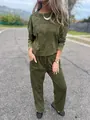 Full body outdoor view of a woman wearing a distressed olive green casual two-piece set - S / Top And Bottom / Green