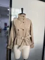 Detail of a chic khaki short trench coat featuring a stand collar and waist belt. - S / Tops / Khaki