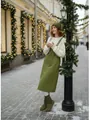 Detailed view of the olive green midi overall dress in a festive outdoor winter setting - M / Dark Green