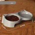 Doppia ciotola grigia minimalista per gatti con acqua e cibo su parquet legno - Doppia Ciotola Anti-Perdita / Set Doppia Ciotola / Grigio Minimalista