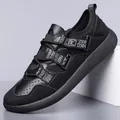 Side profile of black retro chunky sneakers with decorative letter straps and mesh panels. - 39 / Black