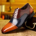 Detailed side view of a tri-color leather brogue shoe with intricate wingtip perforations. - 39 / Colorblock (5659)