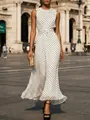 Elegant white sleeveless maxi dress with black polka dot pattern in a street setting - S / Dresses / White