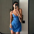 Chic blue polka dot mini dress with spaghetti straps shown in a mirror selfie detail - S / Blue