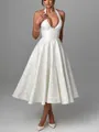 Full view of elegant white jacquard halter dress with deep V-neck and pleated skirt - S / Dresses / White