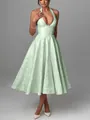 Detail showing the elegant jacquard pattern on a mint green halter neck evening midi dress - Green