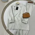 Detailed view of women's linen two-piece set including a double-breasted blazer - XS / Top And Bottom / Light Gray