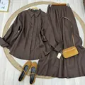 Elegant brown long-sleeved shirt and maxi skirt set with matching tan accessories. - XS / Top And Bottom / Coffee