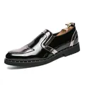 Stylish black patent leather brogue shoes with rivet detailing and slip-on design. - 38 / Silver