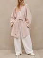Full body view of a woman in a light pink loose linen-style belted cardigan coat - S / Tops / Pink