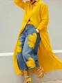 Detailed view of a long yellow button-down shirt dress with a stylish lapel collar. - S / Dresses / Yellow