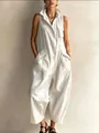 Detail view of white sleeveless utility jumpsuit featuring multiple pockets and stand collar - White