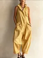 Detailed view of yellow sleeveless utility jumpsuit with stand-up collar and wide legs - Yellow