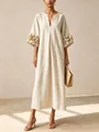 Detailed view of the oversized 3D flower applique on the sleeves of a beige linen dress - S / Dresses / Off White