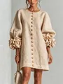 Close-up of elegant French linen dress featuring 3D flower cuffs and lantern sleeves - Apricot