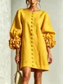 Detail of yellow French dress featuring 3D floral accents on lantern sleeves - Yellow