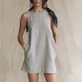 Detail view of a light grey cotton linen sleeveless mini dress with side pockets - Gray