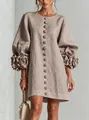 Detailed view of 3D floral appliqués on lantern sleeves of a taupe linen dress - Space Gray